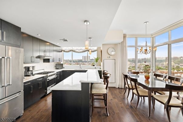 Chandelier, Dining room, Interior, Kitchen, Pendant Lights, Recessed Lighting, Stainless Steel Appliances, Wood Texture Flooring
