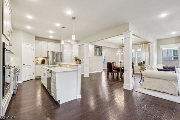 Chandelier, Dining room, Interior, Kitchen, Living room, Pendant Lights, Recessed Lighting, Stainless Steel Appliances, Wood Texture Flooring