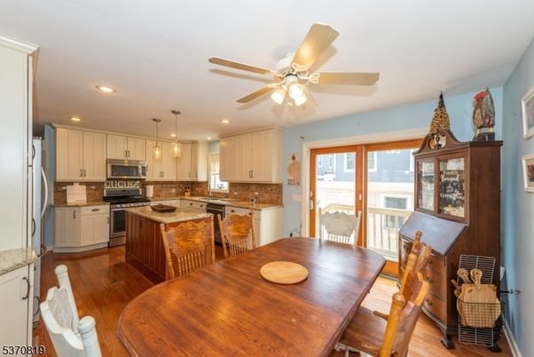 Dining room, Interior, Kitchen, Pendant Lights, Recessed Lighting, Stainless Steel Appliances, Wood Texture Flooring