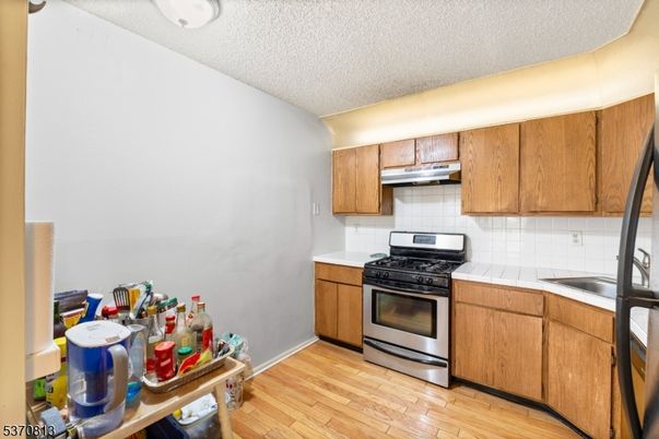 Interior, Kitchen, Stainless Steel Appliances, Tile Countertops, Wood Texture Flooring