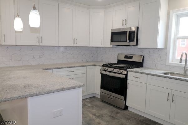 Interior, Kitchen, Marble Walls, Pendant Lights, Recessed Lighting, Stainless Steel Appliances