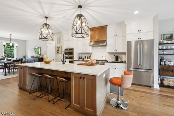 Chandelier, Dining room, Interior, Kitchen, Pendant Lights, Recessed Lighting, Stainless Steel Appliances, Wood Texture Flooring