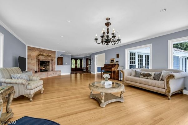 Chandelier, Fireplace, Interior, Living room, Piano, Recessed Lighting, Wood Texture Flooring