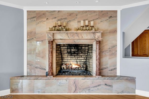 Fireplace, Interior, Marble Walls, Recessed Lighting, Wood Texture Flooring