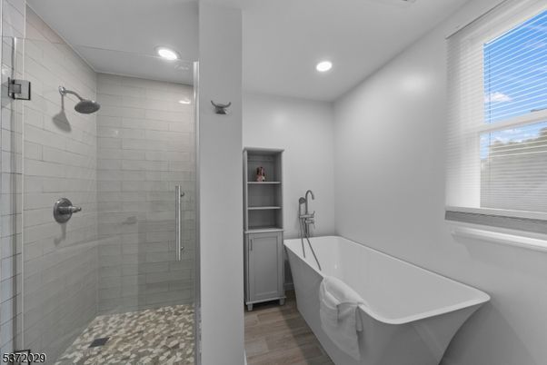Bathroom, Free Standing Baths, Glass Shower, Interior, Recessed Lighting, Wood Texture Flooring