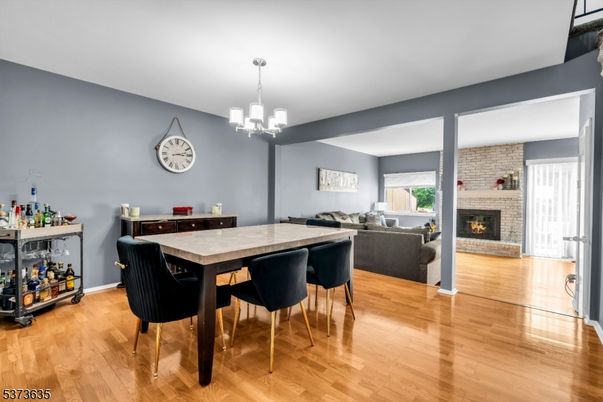Dining room, Fireplace, Interior, Living room, Pendant Lights, Stone Walls, Wood Texture Flooring