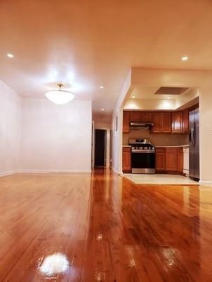 Empty room, Interior, Kitchen, Recessed Lighting, Stainless Steel Appliances, Wood Texture Flooring