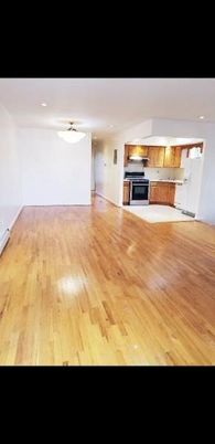 Empty room, Interior, Kitchen, Recessed Lighting, Stainless Steel Appliances, Wood Texture Flooring
