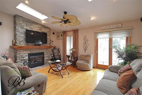 Fireplace, Interior, Living room, Recessed Lighting, Stone Walls, Wood Texture Flooring