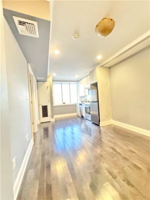 Empty room, Interior, Kitchen, Pendant Lights, Recessed Lighting, Stainless Steel Appliances, Wood Texture Flooring