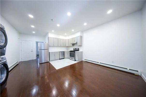 Interior, Kitchen, Recessed Lighting, Washer, Wood Texture Flooring