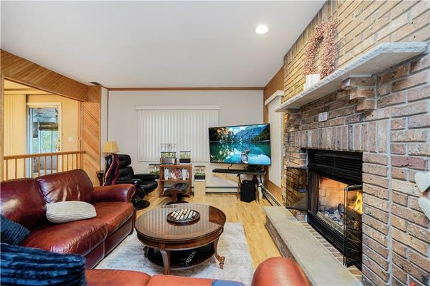 Fireplace, Interior, Living room, Recessed Lighting, Stone Walls, Wood Texture Flooring