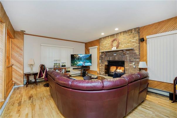 Fireplace, Interior, Living room, Recessed Lighting, Stone Walls, Wood Texture Flooring
