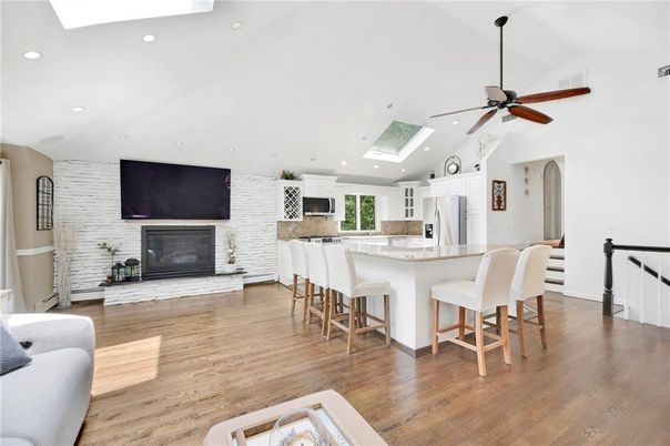 Fireplace, Interior, Kitchen, Recessed Lighting, Stainless Steel Appliances, Stone Walls, Wood Texture Flooring