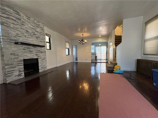 Chandelier, Empty room, Fireplace, Interior, Recessed Lighting, Stone Walls, Wood Texture Flooring