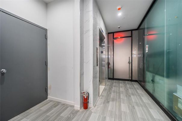 Elevator, Interior, Marble Walls, Recessed Lighting, Wood Texture Flooring