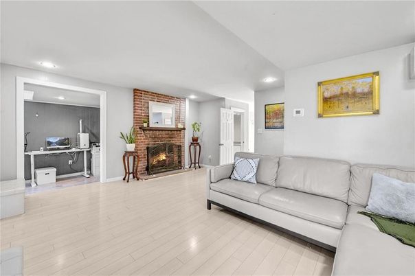 Fireplace, Interior, Living room, Recessed Lighting, Stone Walls, Wood Texture Flooring