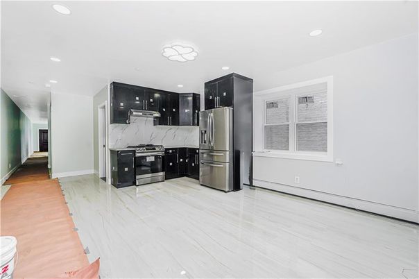 Interior, Kitchen, Marble Walls, Recessed Lighting, Stainless Steel Appliances, Wood Texture Flooring