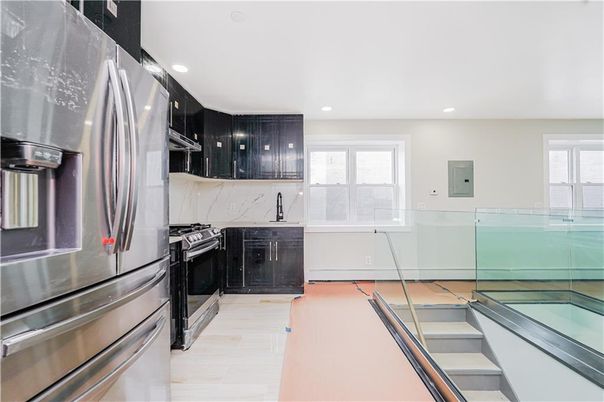 Interior, Kitchen, Marble Walls, Recessed Lighting, Stainless Steel Appliances, Wood Texture Flooring