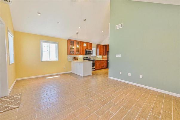 Empty room, Interior, Kitchen, Pendant Lights, Recessed Lighting, Stainless Steel Appliances, Wood Texture Flooring