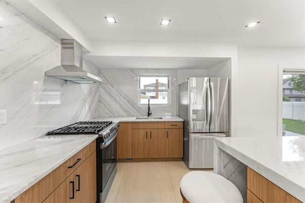 Interior, Kitchen, Marble Walls, Recessed Lighting, Stainless Steel Appliances, Wood Texture Flooring