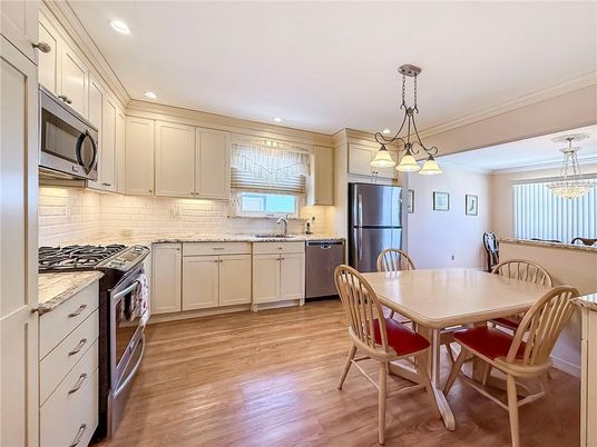 Dining room, Interior, Kitchen, Pendant Lights, Recessed Lighting, Stainless Steel Appliances, Wood Texture Flooring
