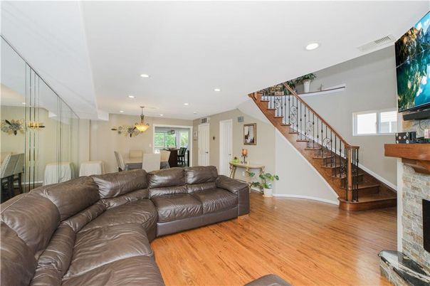 Dining room, Fireplace, Interior, Living room, Recessed Lighting, Wood Texture Flooring