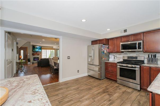 Dining room, Fireplace, Interior, Kitchen, Recessed Lighting, Stainless Steel Appliances, Wood Texture Flooring