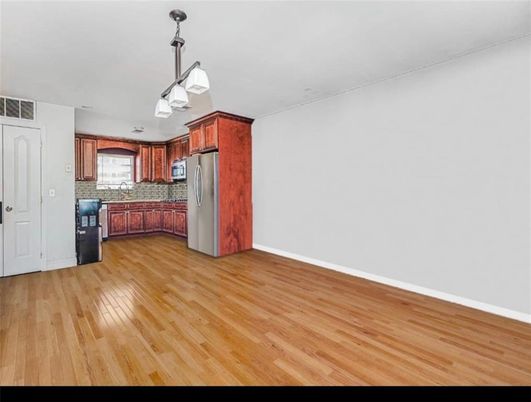 Empty room, Interior, Kitchen, Pendant Lights, Stainless Steel Appliances, Wood Texture Flooring