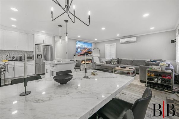 Fireplace, Interior, Kitchen, Living room, Pendant Lights, Recessed Lighting, Stainless Steel Appliances, Wood Texture Flooring