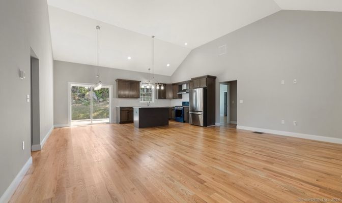 Empty room, Interior, Kitchen, Pendant Lights, Recessed Lighting, Stainless Steel Appliances, Wood Texture Flooring