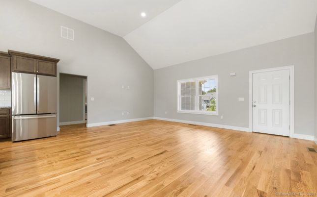 Empty room, Interior, Kitchen, Recessed Lighting, Stainless Steel Appliances, Wood Texture Flooring