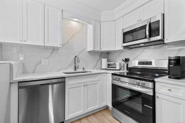 Interior, Kitchen, Marble Walls, Stainless Steel Appliances, Wood Texture Flooring