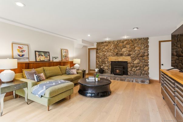 Fireplace, Interior, Living room, Recessed Lighting, Stone Walls, Wood Texture Flooring