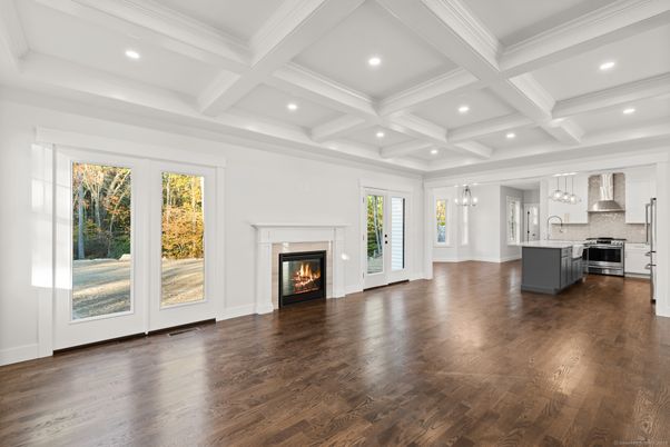 Empty room, Fireplace, Interior, Kitchen, Pendant Lights, Recessed Lighting, Stainless Steel Appliances, Wood Texture Flooring