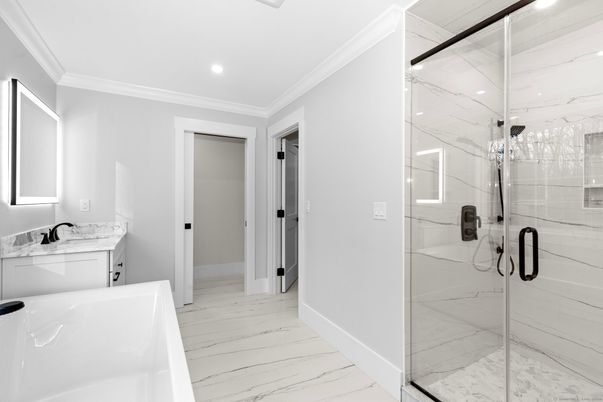 Bathroom, Dual Sink Vanities, Glass Shower, Interior, Marble, Marble Walls, Recessed Lighting