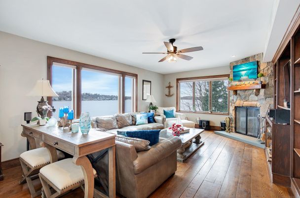 Fireplace, Interior, Living room, Recessed Lighting, Stone Walls, Water, Wood Texture Flooring