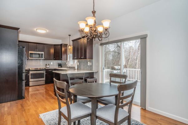 Chandelier, Dining room, Interior, Kitchen, Stainless Steel Appliances, Wood Texture Flooring