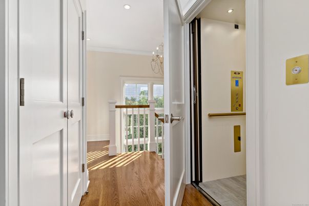 Chandelier, Elevator, Interior, Recessed Lighting, Wood Texture Flooring