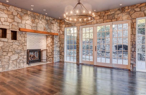 Chandelier, Empty room, Fireplace, Interior, Recessed Lighting, Stone Walls, Wood Texture Flooring