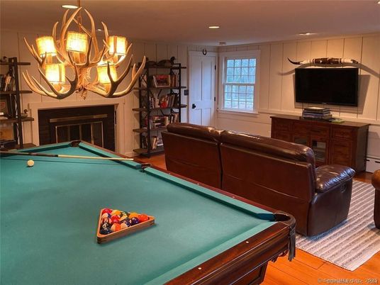 Billiard Table, Chandelier, Fireplace, Game Room, Interior, Recessed Lighting, Wood Texture Flooring
