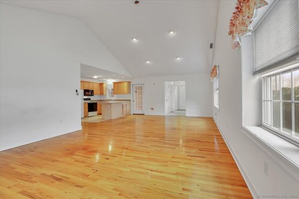 Empty room, Interior, Kitchen, Recessed Lighting, Stainless Steel Appliances, Wood Texture Flooring