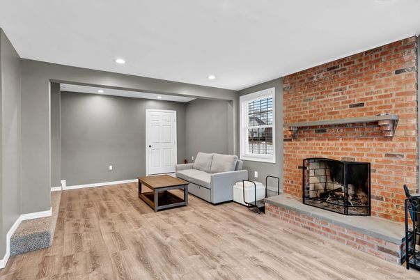 Fireplace, Interior, Living room, Recessed Lighting, Stone Walls, Wood Texture Flooring