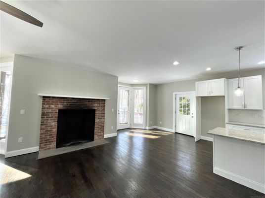 Empty room, Fireplace, Interior, Kitchen, Pendant Lights, Recessed Lighting, Stone Walls, Wood Texture Flooring