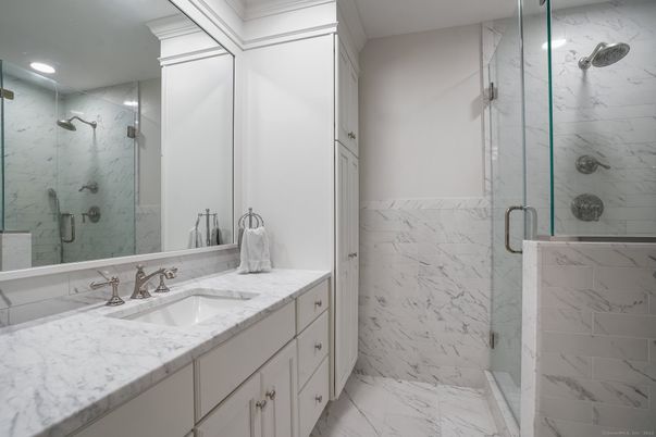 Bathroom, Dual Sink Vanities, Glass Shower, Interior, Marble, Marble Walls, Recessed Lighting
