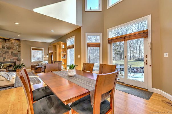 Dining room, Fireplace, Interior, Living room, Recessed Lighting, Stone Walls, Wood Texture Flooring