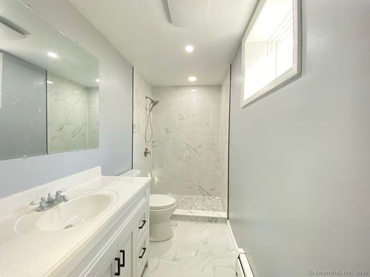 Bathroom, Dual Sink Vanities, Glass Shower, Interior, Marble, Marble Walls, Recessed Lighting