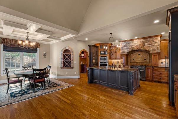 Chandelier, Dining room, Interior, Kitchen, Recessed Lighting, Stainless Steel Appliances, Stone Walls, Wood Texture Flooring