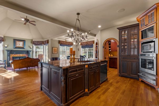 Chandelier, Fireplace, Interior, Kitchen, Living room, Recessed Lighting, Wood Texture Flooring