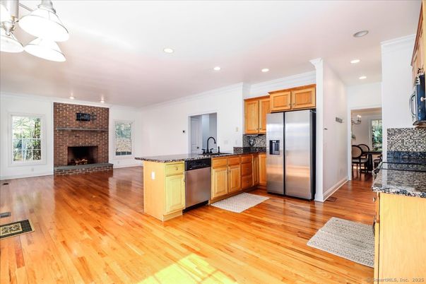 Fireplace, Interior, Kitchen, Recessed Lighting, Stainless Steel Appliances, Stone Walls, Wood Texture Flooring